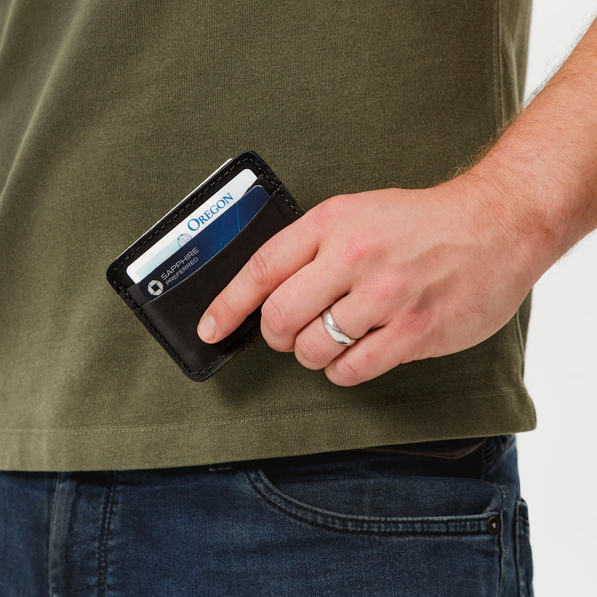 Black | Model hodling minimalist leather wallet with card slots