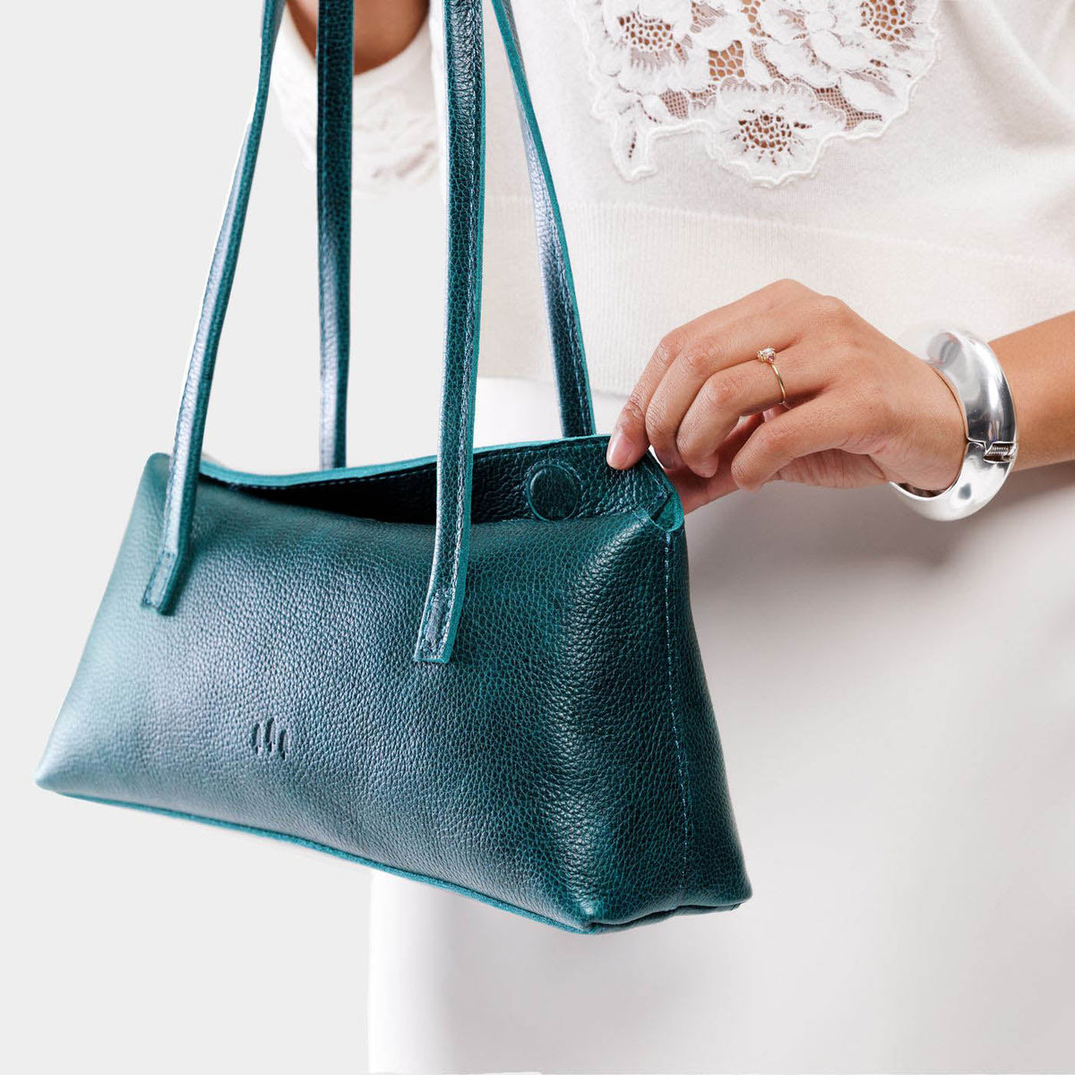 Lagoon | Person holding leather bowler bag with magnetic closure