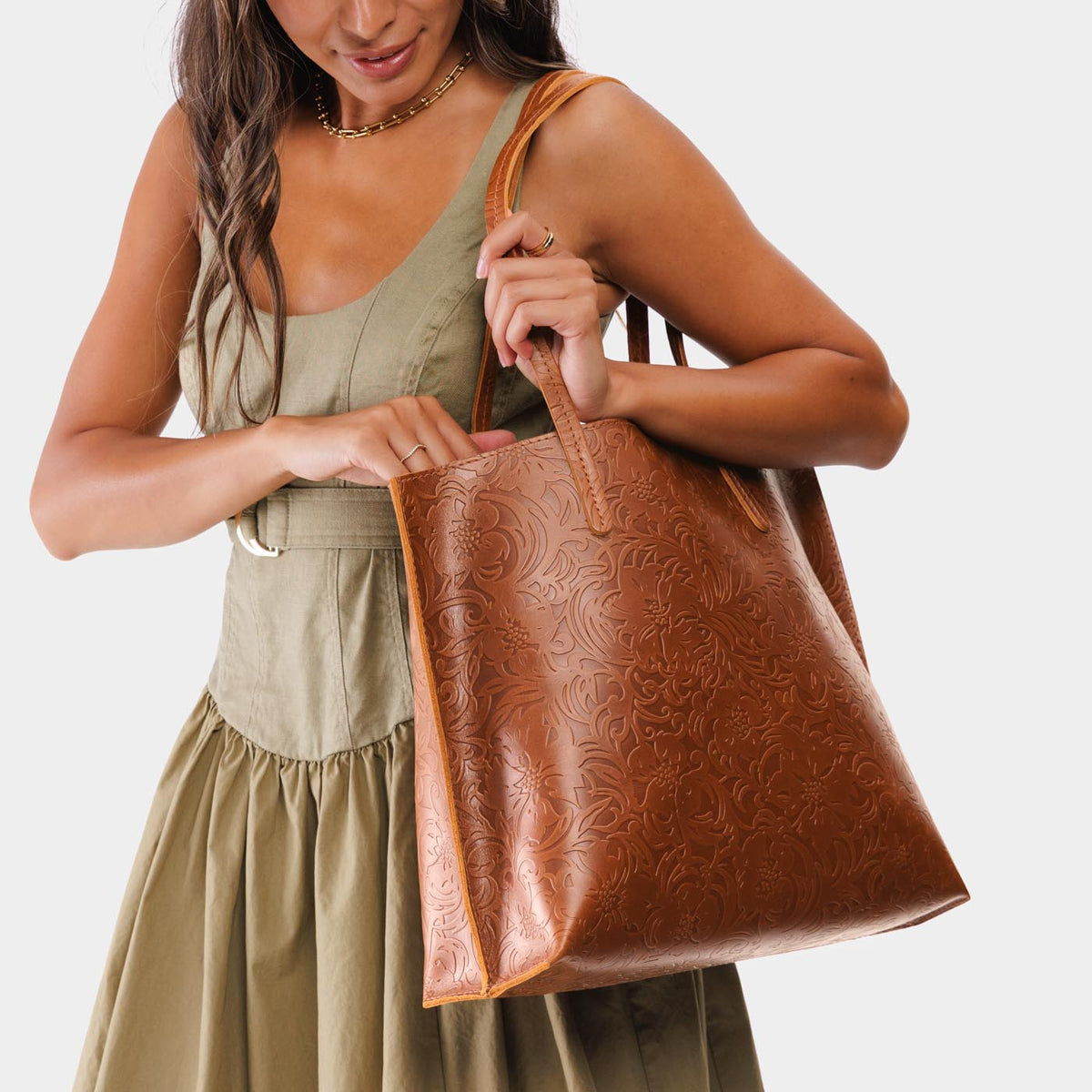 Meadow*Large | Model holding leather tote bag with interior snap key loop