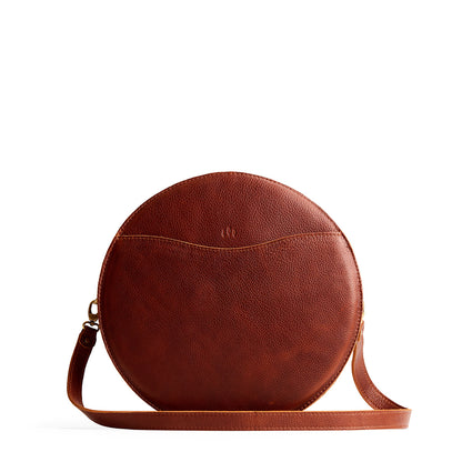 Nutmeg | Large circle shaped leather bag with top zipper and carrying strap