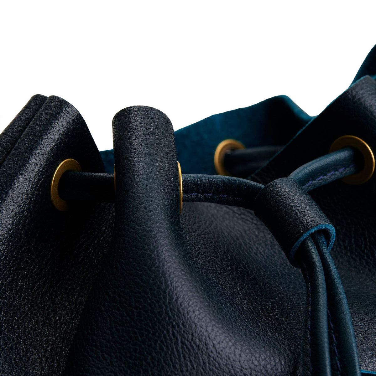 Boreal | Close-up of a leather drawstring backpack with grommets.