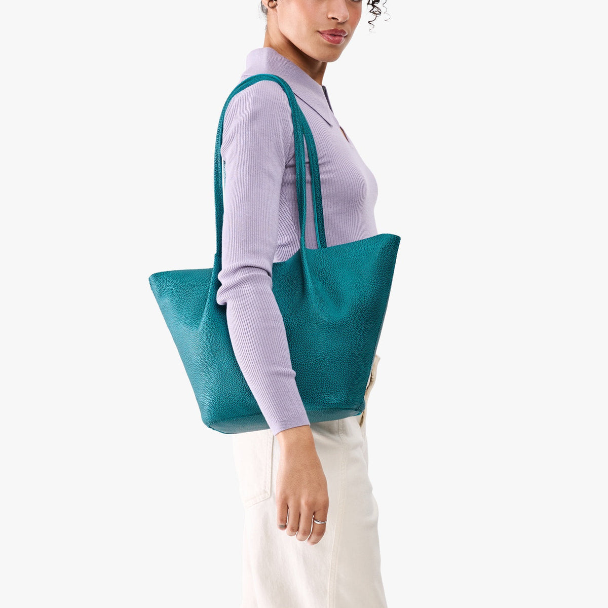 Aquarius*Large | Model wearing lavender sweater and white pants carrying wide bucket shaped tote bag with matching leather handles