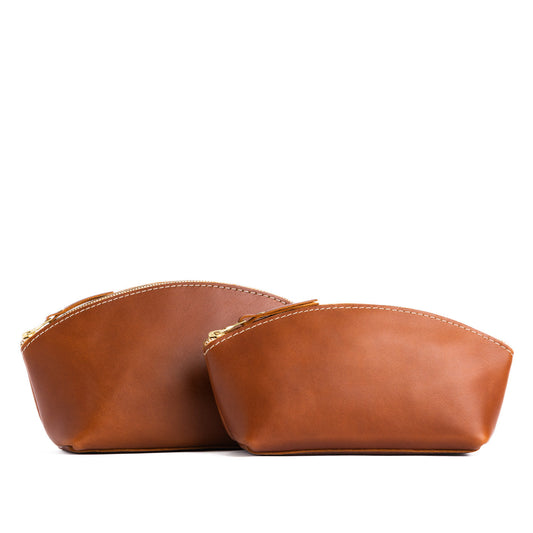 Honey | Size comparison shot of two spacious leather makeup bags with curved seams and top zipper
