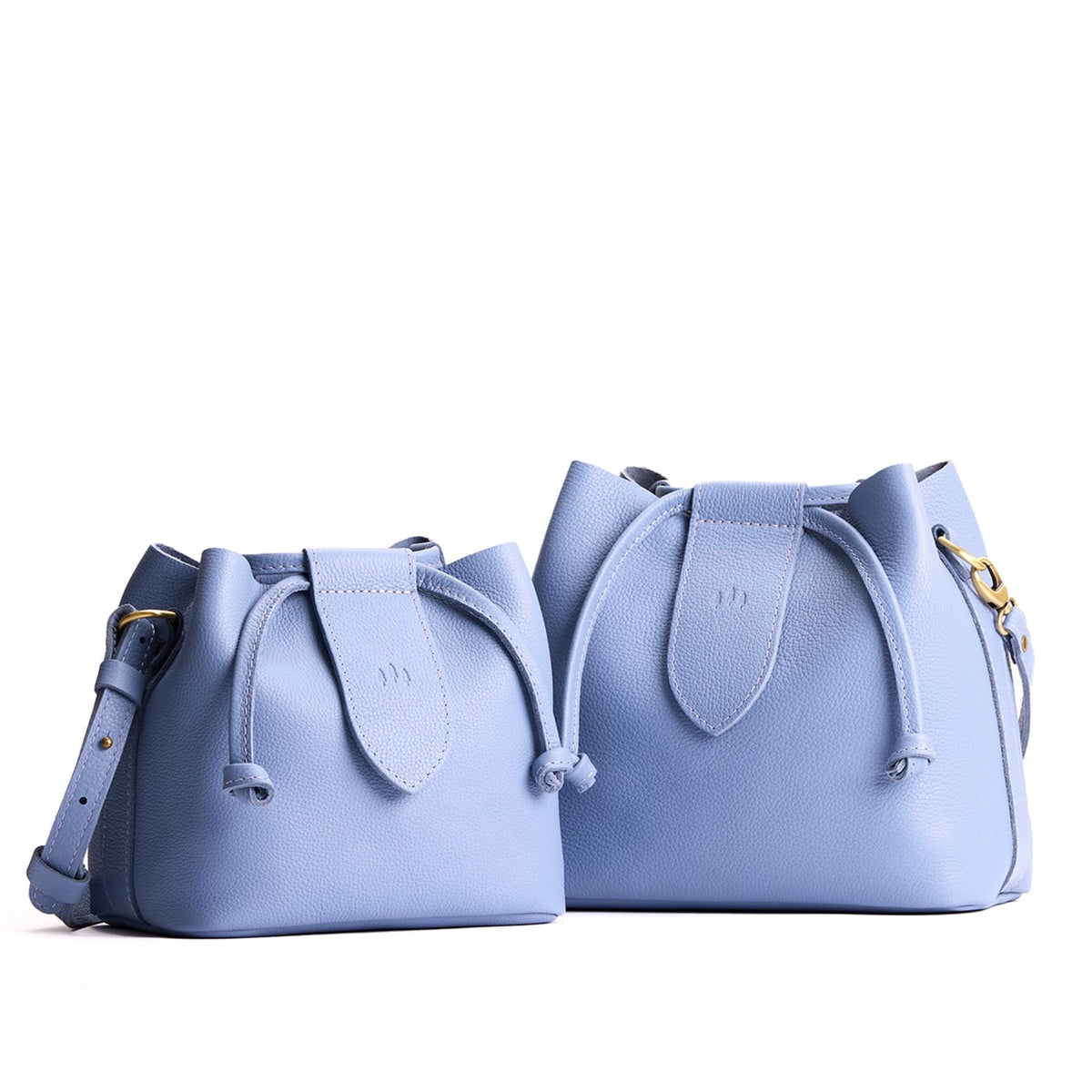 Aster | Small and large symmetrical leather bags with leather drawstring closure and adjustable shoulder strap