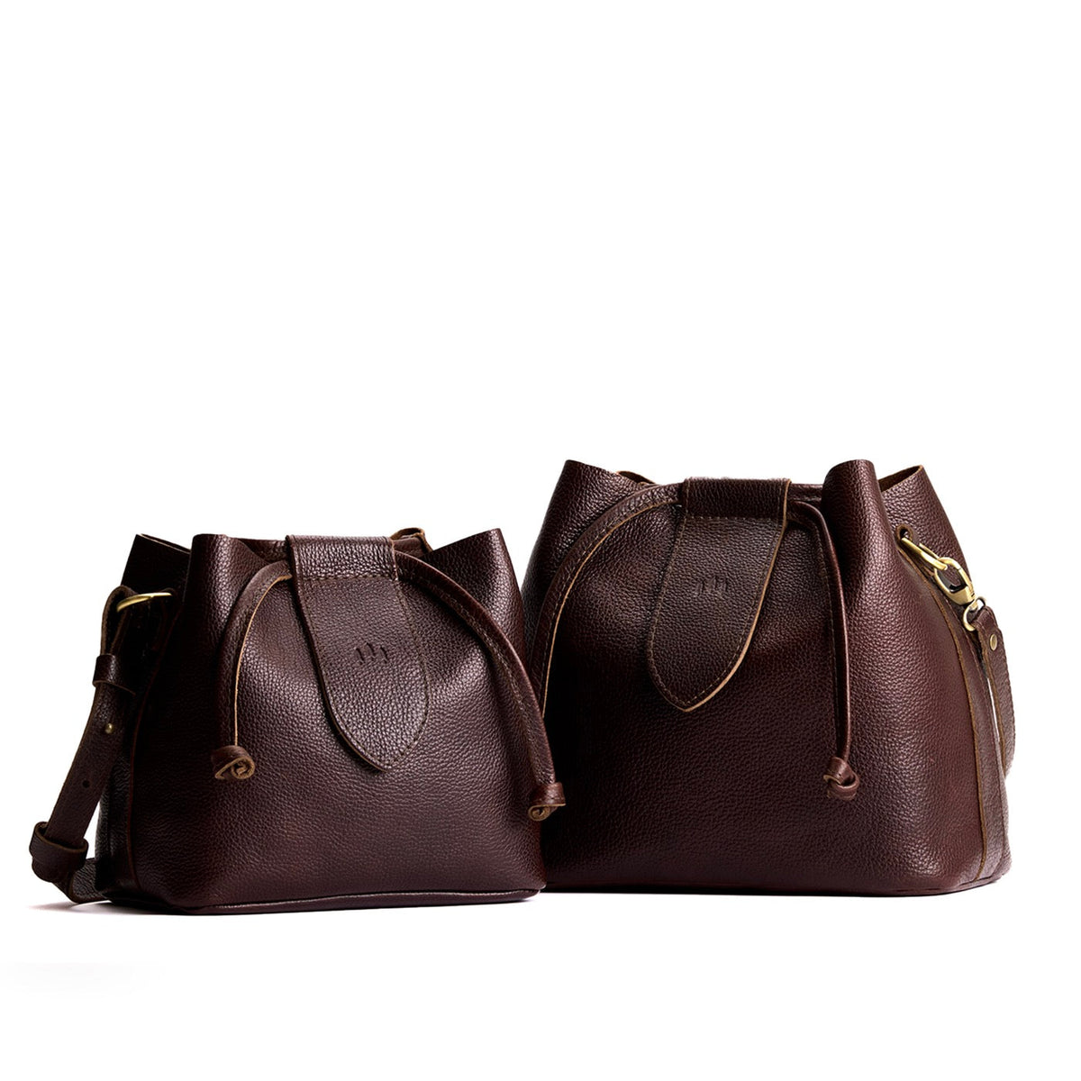 Coldbrew | Small and large symmetrical leather bags with leather drawstring closure and adjustable shoulder strap