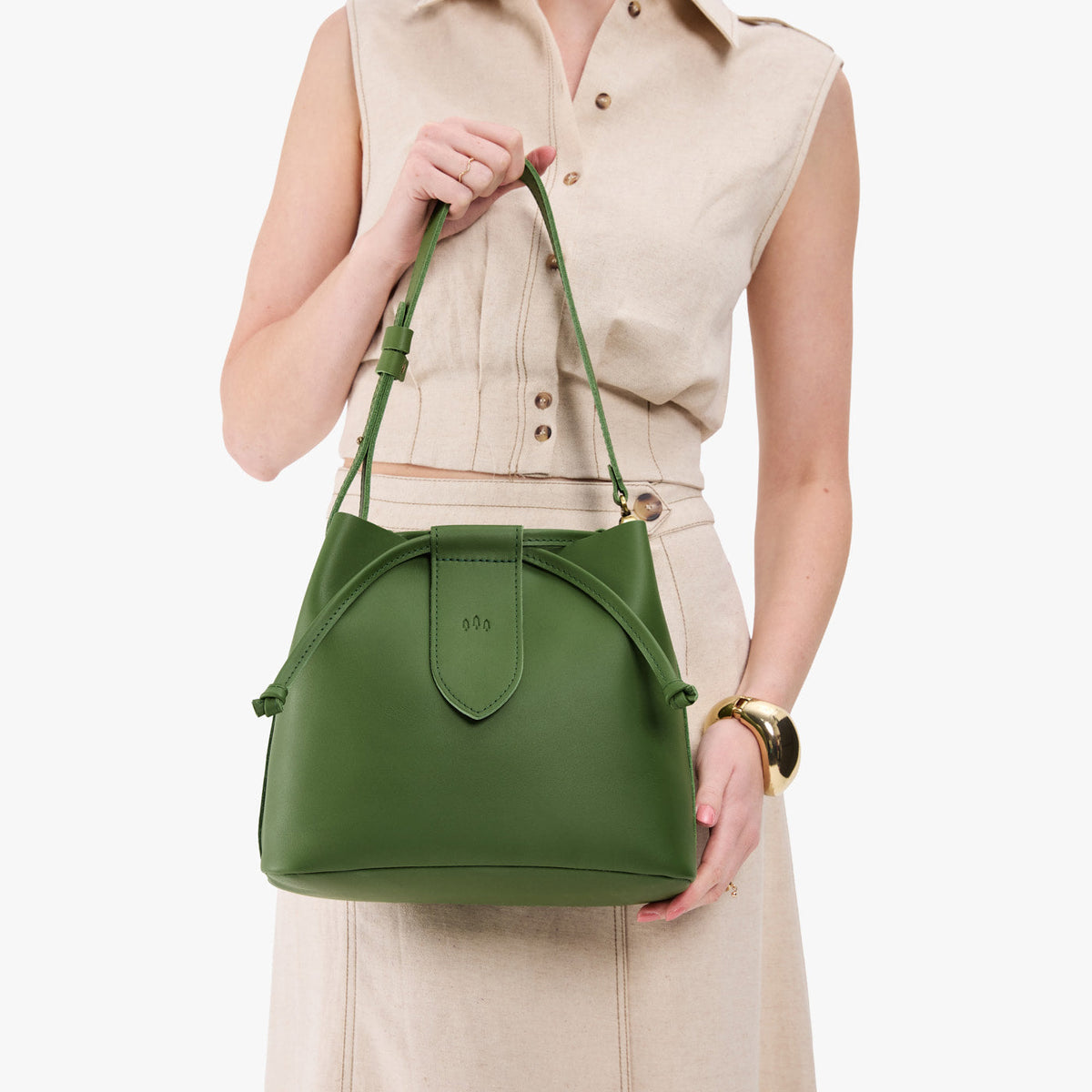 Cactus*Large | Model holding symmetrical leather bag with leather drawstring closure and adjustable shoulder strap