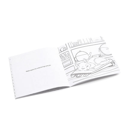 Coloring book pages with a black and white illustration of a cat on laying on a backpack.