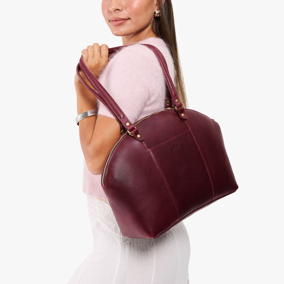 Cabernet*Large | Model holding a half circle crossbody bag with handles and removable crossbody strap
