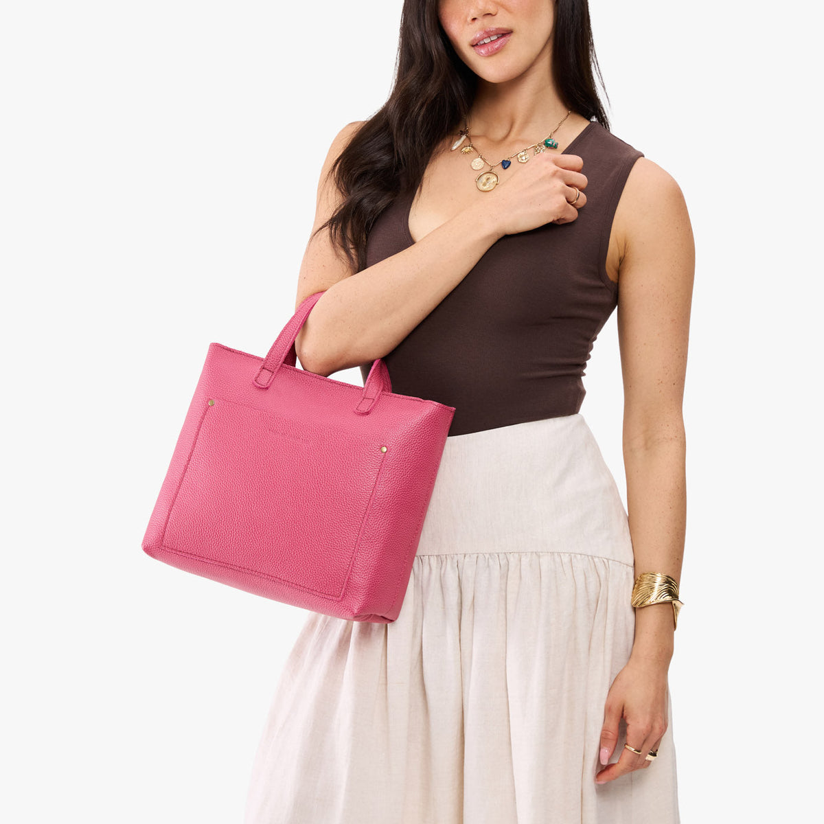 Wild Rose*Zipper | Model holding midsize crossbody tote with handles and a pocket