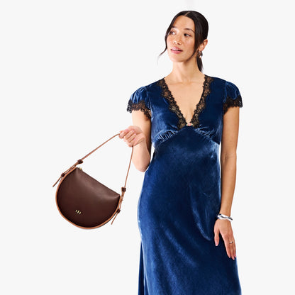 Cognac | Model wearing a rounded structured shoulder bag