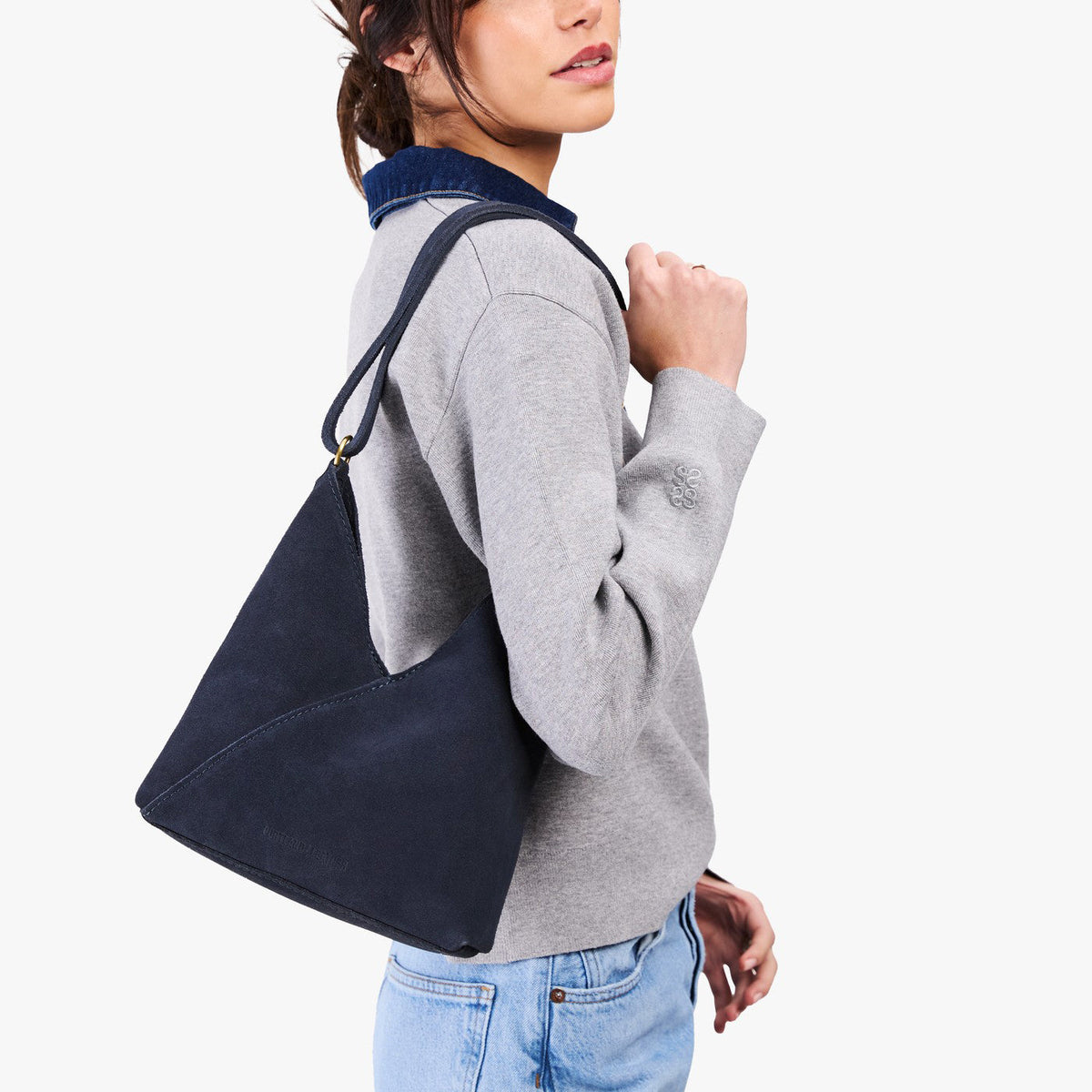 Alaska Blue*Small | Model wearing petite shoulder bag with adjustable strap and magnetic snap closure