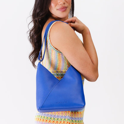Astro Blue*Small | Model wearing petite shoulder bag with adjustable strap and magnetic snap closure