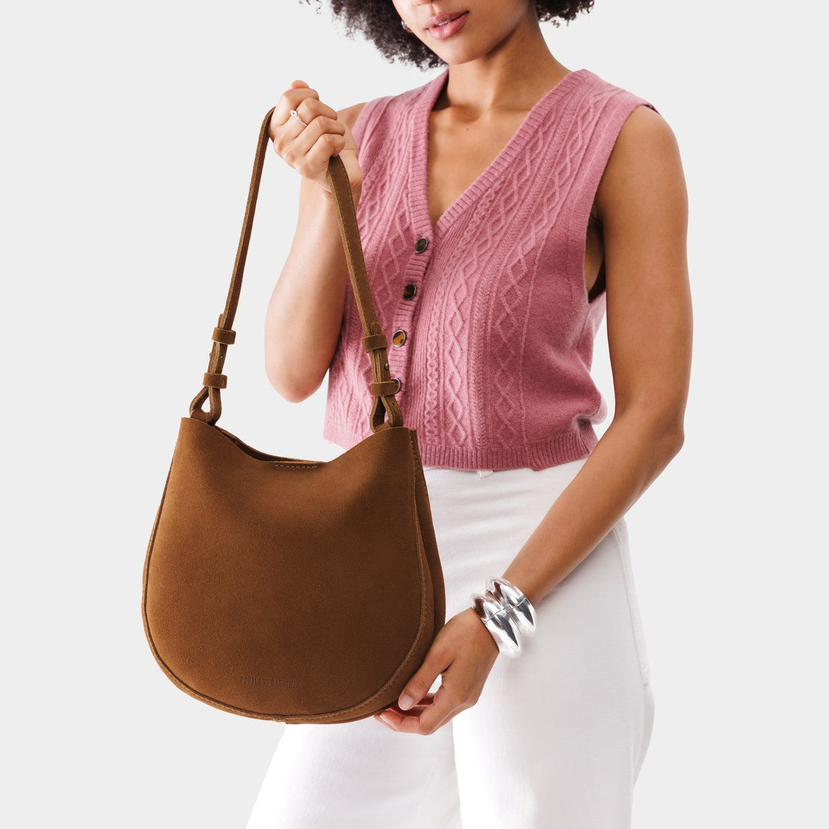 Jackson*Medium | Woman wearing rounded shoulder bag with adjustable strap on a white background