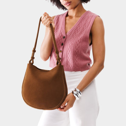 Jackson*Medium | Woman wearing rounded shoulder bag with adjustable strap on a white background