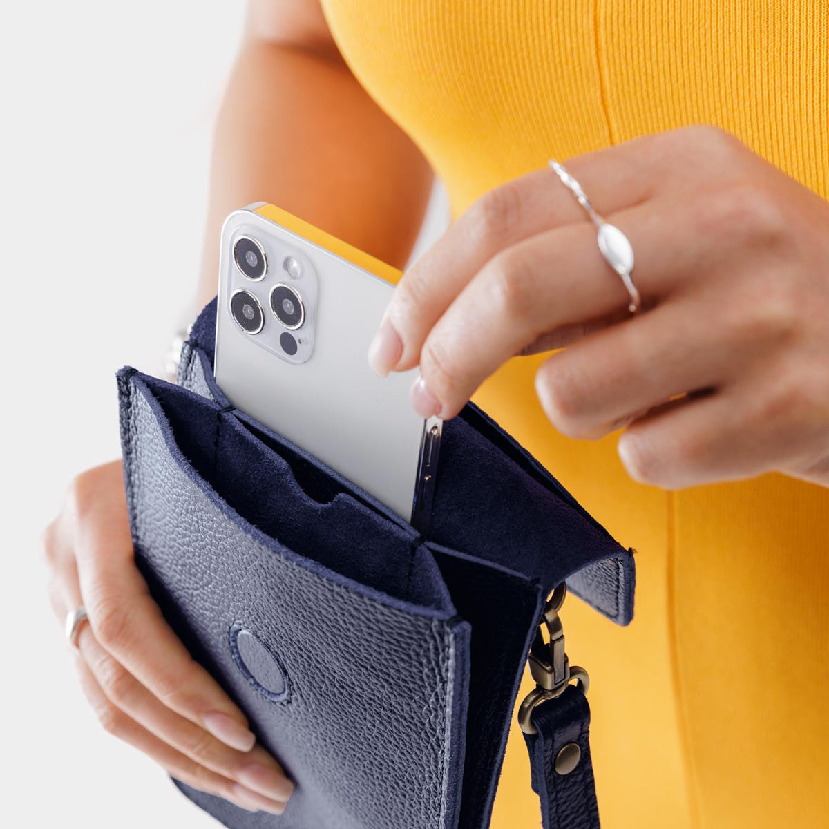 Cobalt | Model wearing slim, phone-shaped crossbody purse with magnetic closure