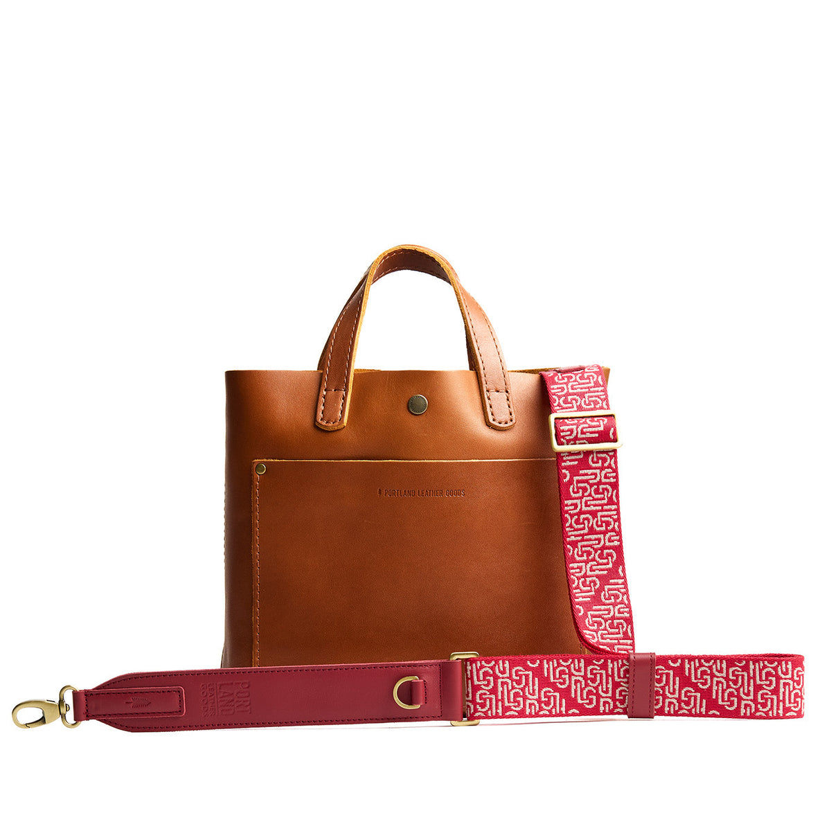 Firepop | Leather and webbing strap with repeating PLG lettering on a leather bag