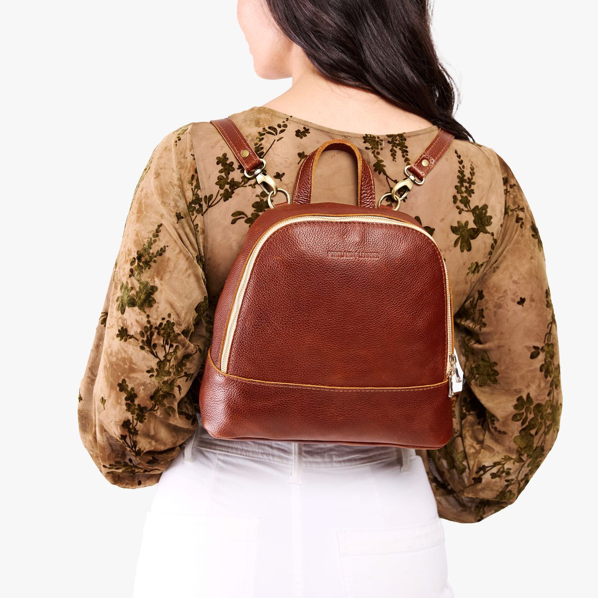 Nutmeg | Model wearing leather backpack with debossed Portland Leather logo on front