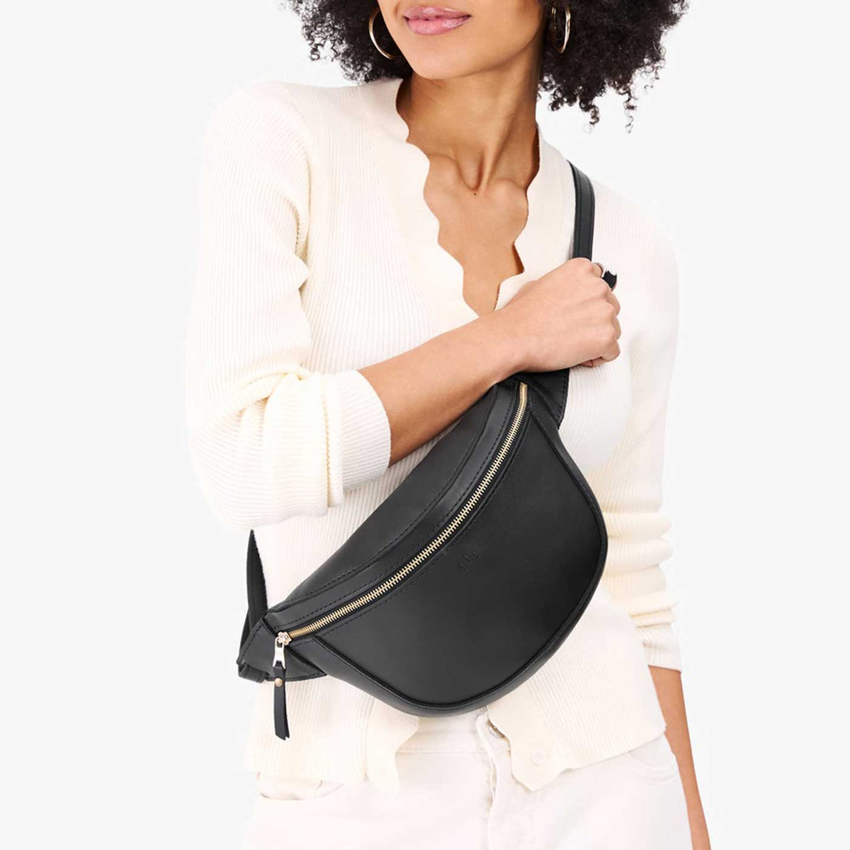 Black | Model wearing a sling bag with front zipper