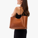 Honey*Large | Woman carrying a wide tote with leather straps and snap closure